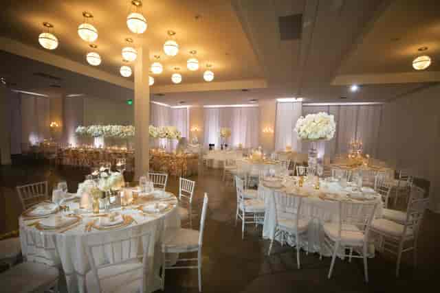 Elegant ballroom venue with floral centerpieces for weddings and upscale events.