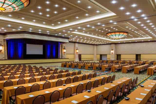 Spacious Grapevine Convention Center meeting venue with arranged tables and presentation stage.