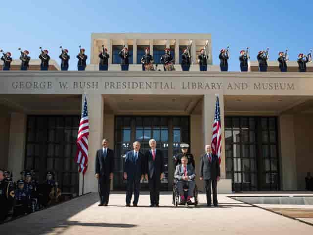 George W. Bush Presidential Museum event with dignitaries, flags, and a military band.