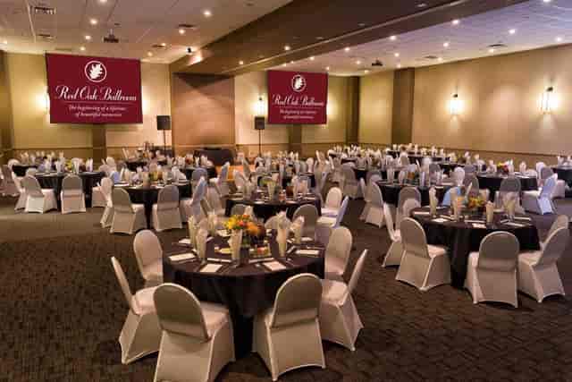 Elegant banquet hall with round tables, ideal for conferences and formal events.