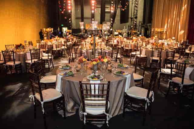 Elegant banquet hall setup for upscale events, featuring round tables and floral centerpieces.