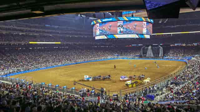 NRG Stadium packed for Houston Rodeo with large screens enhancing audience engagement.