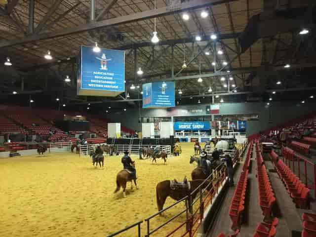 Indoor equestrian arena at Houston Livestock Show and Rodeo, featuring sand floor for competitions.