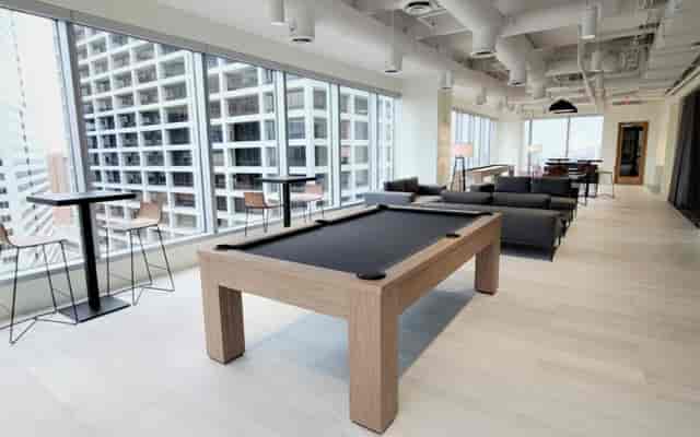 Modern conference lounge with pool table, perfect for networking and casual meetings.