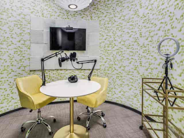 Modern conference space with round table, perfect for hybrid meetings and content creation.