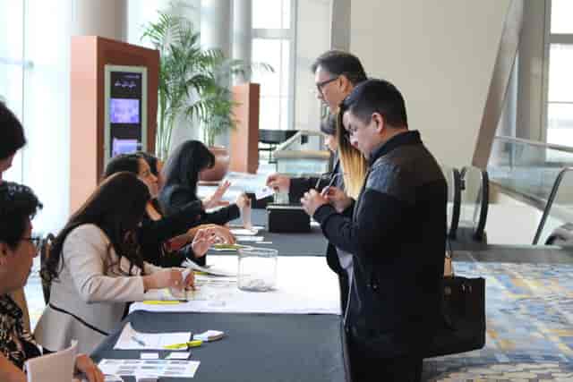 Leadership Conference registration area with attendees at Houston Hispanic Chamber of Commerce.