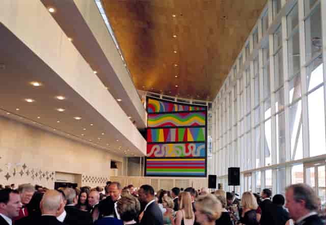 Vibrant networking event in Grand Lobby, The Hobby Center; modern space with high ceilings.