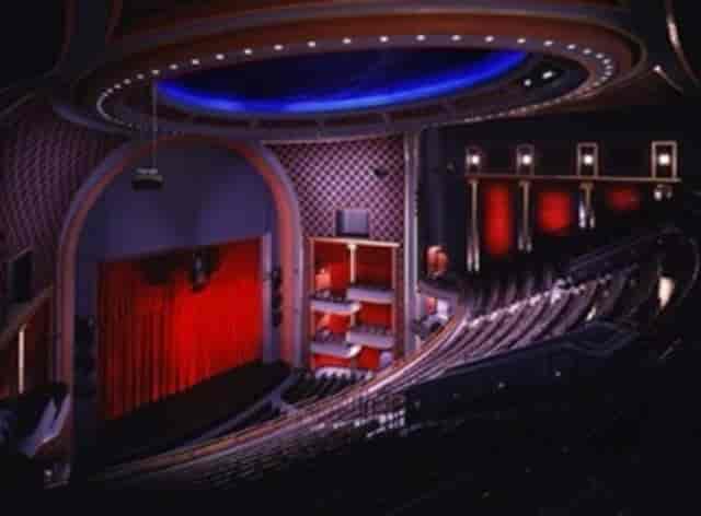 Theater with red curtains and tiered seating for performances at Hobby Center