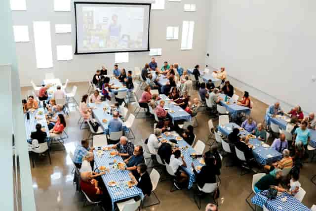 Raible Chapel banquet setup with blue checkered tables for a successful community event.