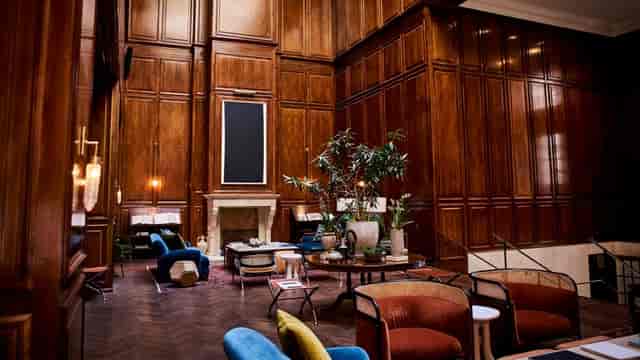 Sophisticated Sam Rayburn Room with rich wood paneling for events and gatherings.