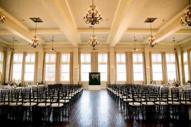 Elegant event space with chandeliers, ideal for weddings and corporate gatherings.