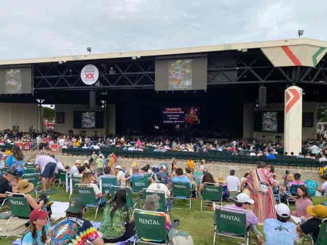 Lawn Area at Dos Equis Pavilion with audience seated for an outdoor performance event.