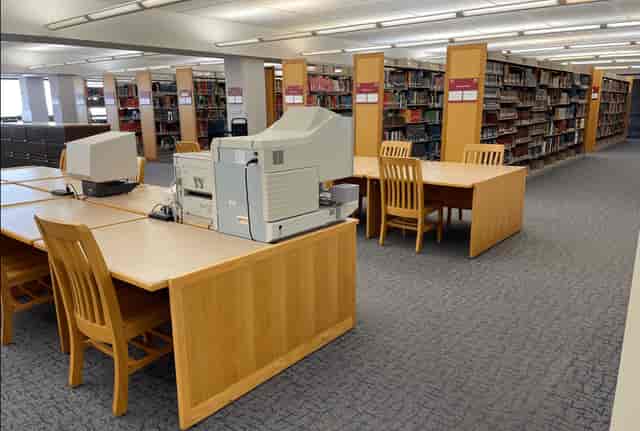 Dallas Public Library interior with wooden tables, ideal for workshops and study sessions.