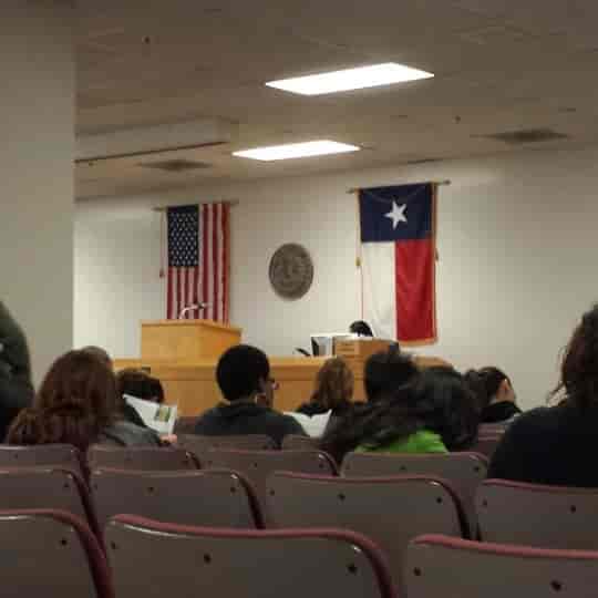 Dallas County Jury Room courtroom with attendees, flags, and professional event setup.