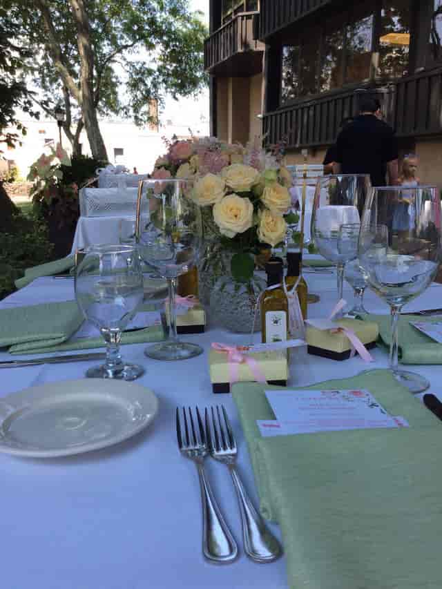 Elegant table setting in La Pergola garden oasis for sophisticated events.