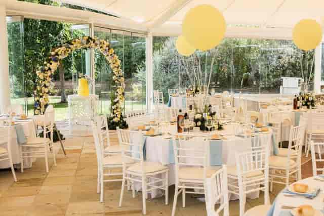 Elegant wedding reception at Sheldon Gardens with floral arch and pastel decor.