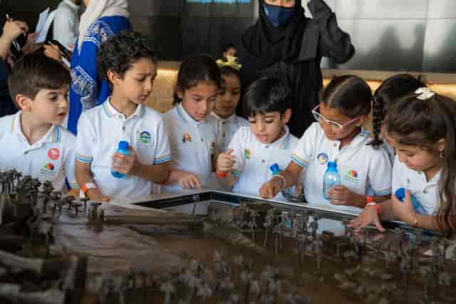 Children interact with a display at Diriyah Horizon event, showcasing hands-on learning.
