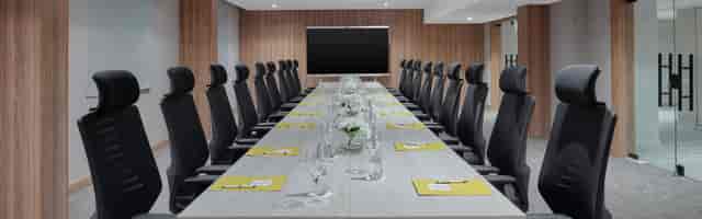 Modern conference room with ergonomic chairs for high-level meetings and presentations.
