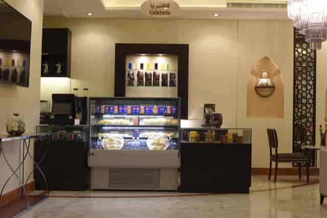 Al Joud Boutique Hotel lobby cafeteria, modern decor, ideal for networking events.