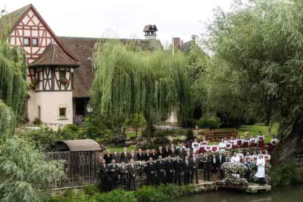 Outdoor wedding venue at Auberge de l'Ill with lush greenery and charming architecture.