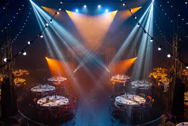 "Illuminated conference tent setup for upscale gala or corporate event dinner."