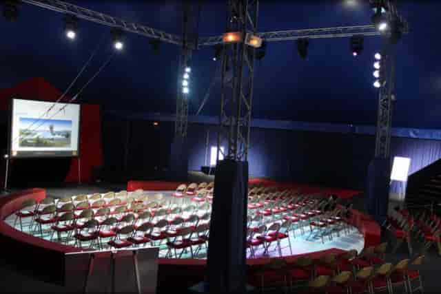 Conference tent with circular seating for innovative events and team-building activities.