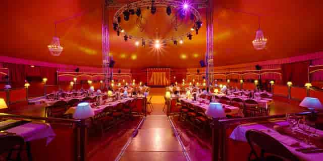 Cocktail Tent in Cirque Imagine with elegant tables, ideal for gatherings and performances.