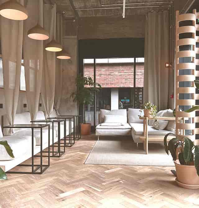 Stylish lounge area with greenery for networking events in Makers Quarter.