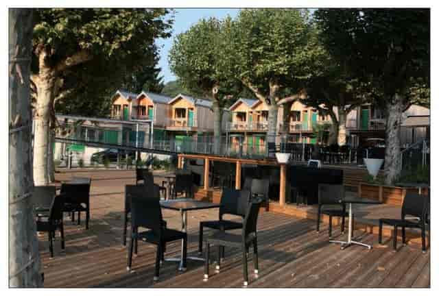Outdoor event space at La Maison des Pêcheurs with modern seating and lush greenery.