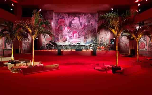 Auditorium at Palais de la Porte Dorée with red carpet, perfect for corporate events.