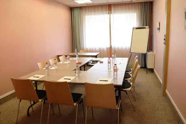 Main Conference Hall at Hôtel des Congrès with a rectangular table for meetings and workshops.