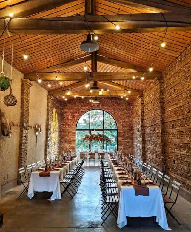 Elegant event space with rustic brick walls, ideal for weddings and corporate gatherings.