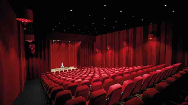 Grand Hall in OL Vallée: red auditorium, tiered seating for conferences and events.