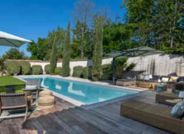Terrasse autour de la piscine at L'Hermitage de Moly, ideal for summer events and gatherings.