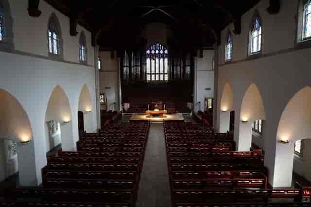 Highland Park United Methodist Church sanctuary with elegant stained glass, perfect for events.