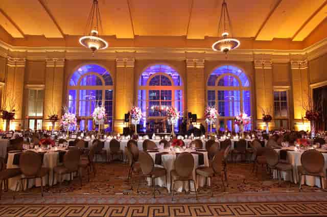 Elegant loggia banquet hall with round tables, ideal for galas and corporate events.