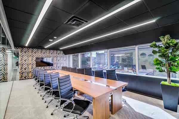 Modern conference room with ergonomic chairs for corporate meetings and presentations.