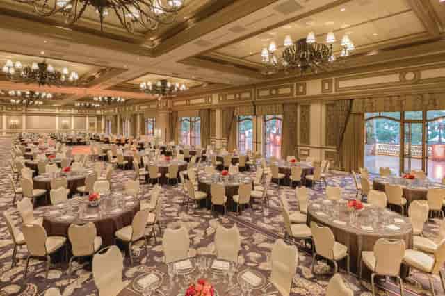 Elegant banquet hall with round tables, ideal for weddings and corporate events.