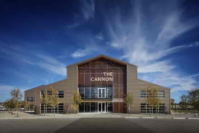 Modern event venue "The Cannon" with spacious glass windows, ideal for gatherings.