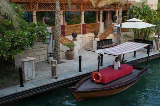 Layali at Jumeirah Al Qasr: serene canal, traditional boat, luxury events.