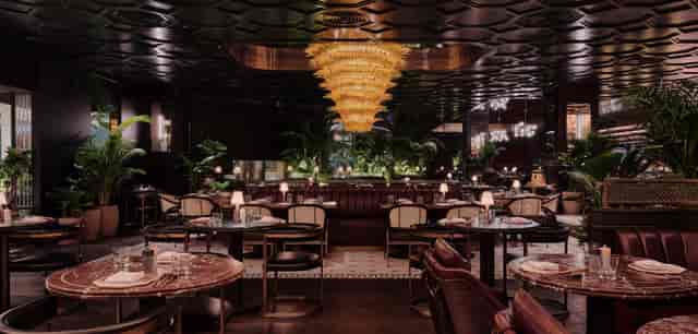 Elegant restaurant venue for upscale corporate events with a luxurious chandelier.