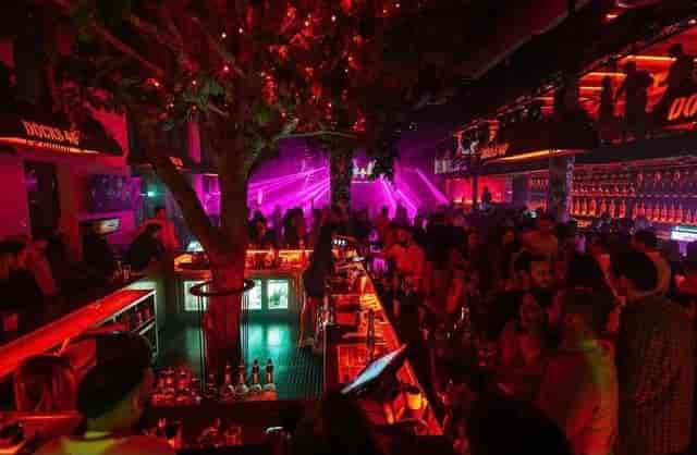 Vibrant bar with glowing lights, ideal for social events or corporate gatherings.