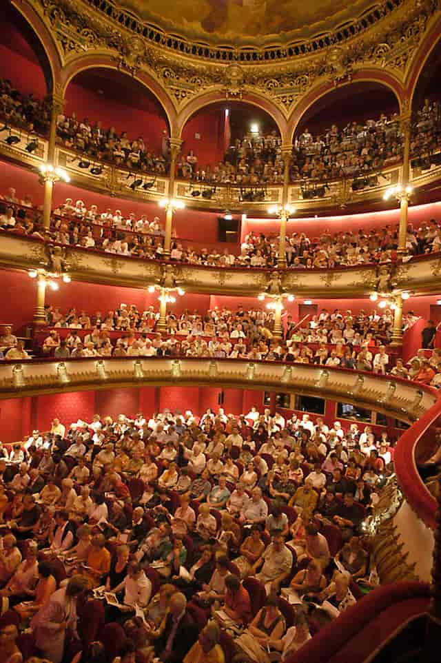 Atrium at Les Célestins, Théâtre de Lyon: vibrant theater event with tiered seating.
