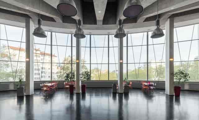 Modern dance hall with large windows - ideal for events and gatherings.