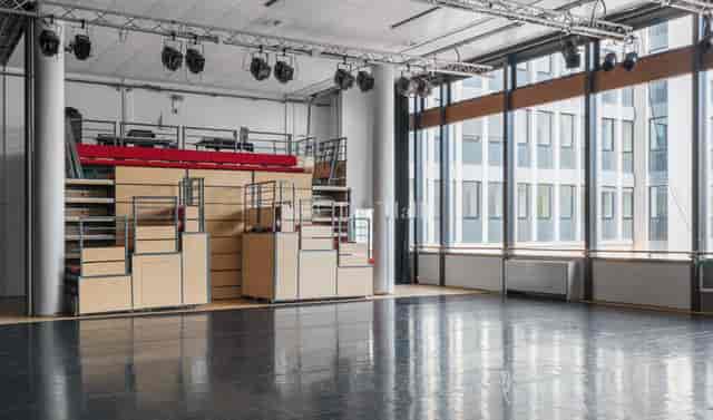 Versatile performing arts theater with tiered seating, perfect for events and workshops.