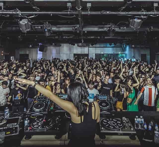 Vibrant nightlife event at Le Sucre's Salle de concert with DJ performance.