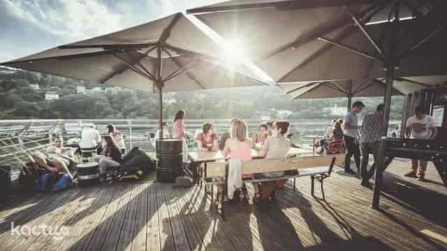 Vibrant rooftop event space with stylish umbrellas, perfect for summer networking.