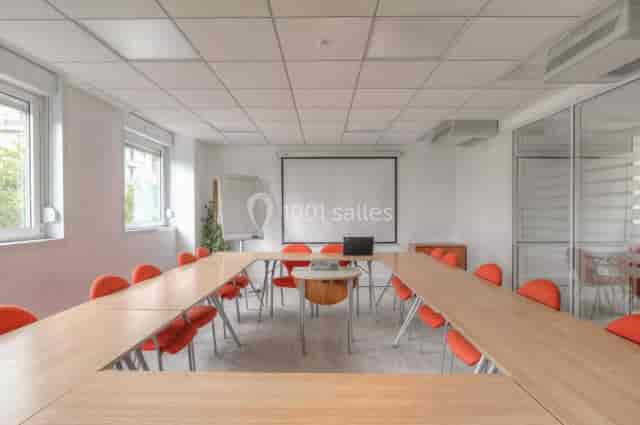 Modern training room with vibrant orange chairs, perfect for workshops and meetings.