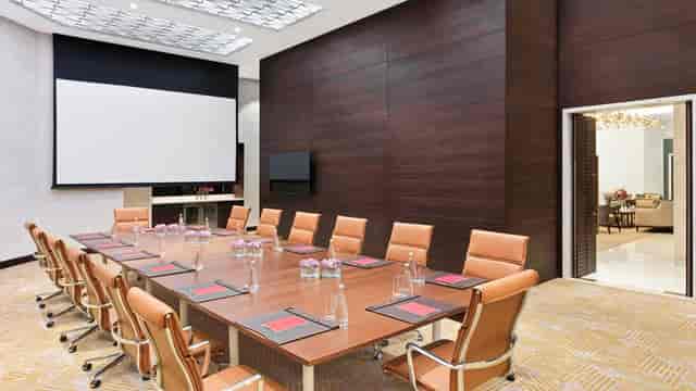 Modern meeting room at Sofitel Dubai with sleek table, ideal for corporate events.
