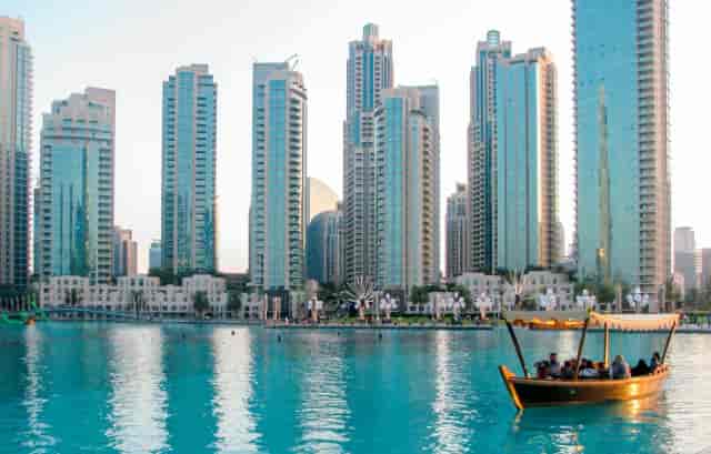 Waterfront view of Marina Promenade with skyscrapers and traditional boat, ideal for events.